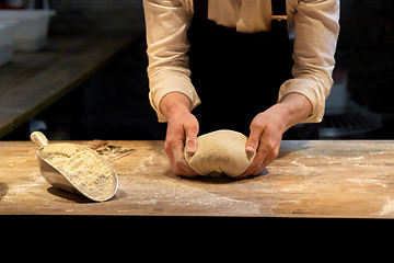 Image showing baker making bread dough at bakery kitchen