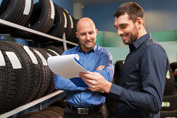 Image showing customer and salesman at car service or auto store