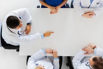 Image showing doctor showing something imaginary on table