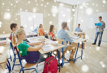 Image showing student boy with notebook and teacher at school