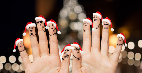 Image showing hands and fingers in santa hats at christmas