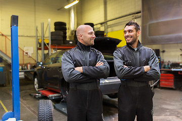 Image showing auto mechanics or tire changers at car shop