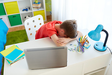 Image showing tired or sad student boy with laptop at home