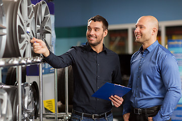 Image showing customer and salesman at car service or auto store