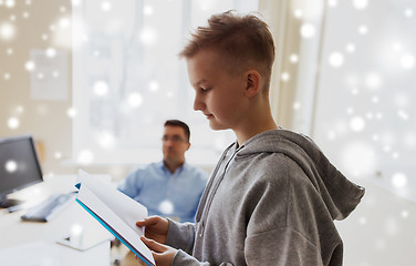 Image showing student boy with notebook and teacher at school