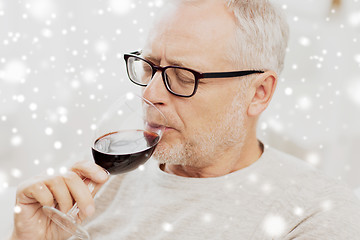 Image showing senior man drinking red wine from glass