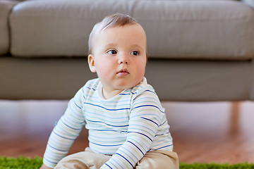 Image showing baby boy sitting on floor at home