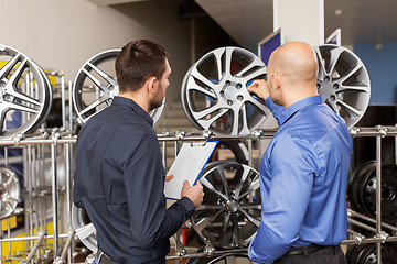 Image showing customer and salesman at car service or auto store