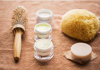 Image showing hair brush, cream, sponge, soap bar and bath towel