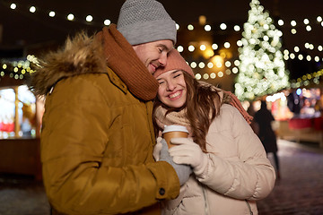 Image showing happy young couple with coffee at christmas market