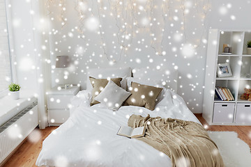 Image showing bedroom with bed and christmas garland at home