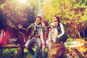 Image showing family with smartphone taking selfie near campfire