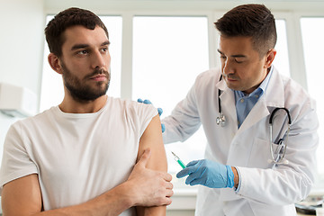 Image showing patient and doctor with syringe doing vaccination