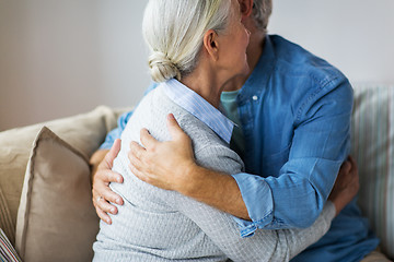 Image showing close up of happy senior couple hugging at home