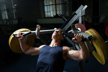 Image showing man doing chest press on exercise machine in gym