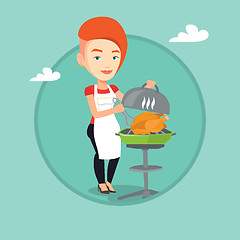 Image showing Woman cooking chicken on barbecue grill.