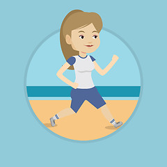 Image showing Young sporty woman jogging on the beach.