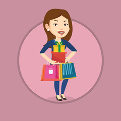 Image showing Happy woman holding shopping bags and gift boxes.