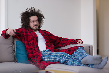 Image showing young man in bathrobe enjoying free time