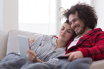 Image showing couple relaxing at  home with tablet computers