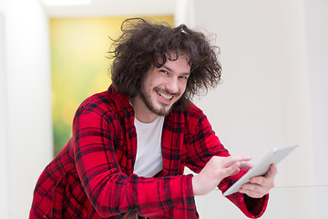 Image showing young freelancer using tablet computer