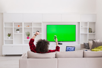 Image showing young man in bathrobe enjoying free time