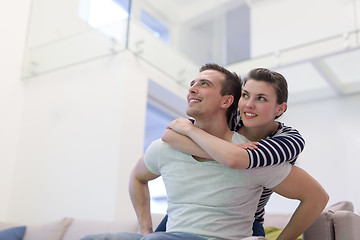 Image showing handsome man piggybacking his girlfriend