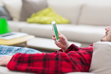 Image showing young man in bathrobe enjoying free time