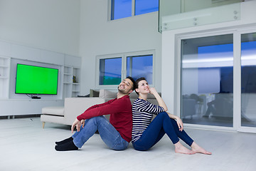 Image showing young couple sitting with back to each other on floor