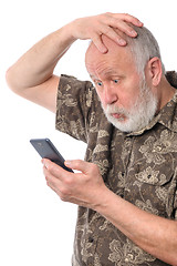 Image showing senior man confused with something at mobile smartphone, isolated on white