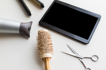 Image showing tablet pc, scissors, hairdryer, hot iron and brush