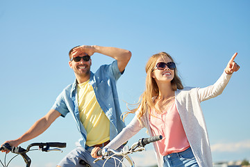 Image showing happy young couple with bicycles outdoors