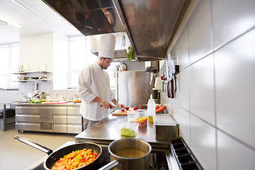 Image showing male chef cooking food at restaurant kitchen