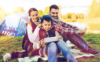 Image showing happy family with tablet pc and tent at camp site