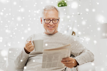 Image showing senior man in glasses reading newspaper at home