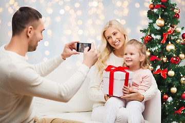 Image showing man photographing his family with christmas gift