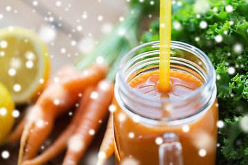 Image showing close up of glass jug or mug with carrot juice