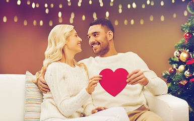 Image showing happy couple with red heart at christmas