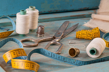 Image showing Retro sewing accessories on blue wooden background