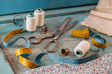 Image showing Retro sewing accessories on blue wooden background