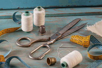 Image showing Retro sewing accessories on blue wooden background