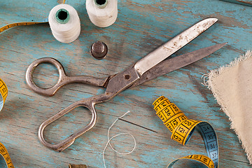 Image showing Retro sewing accessories on blue wooden background