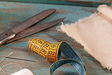 Image showing Retro sewing accessories on blue wooden background