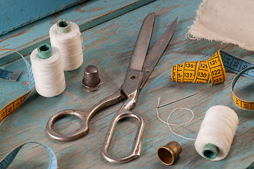 Image showing Retro sewing accessories on blue wooden background