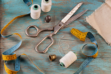 Image showing Retro sewing accessories on blue wooden background