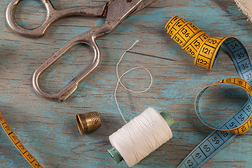 Image showing Retro sewing accessories on blue wooden background