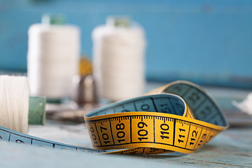 Image showing Retro sewing accessories on blue wooden background