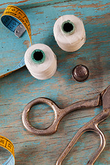 Image showing Retro sewing accessories on blue wooden background