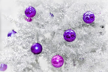 Image showing Decoration ultraviolet baubles on silver artificial Christmas tree