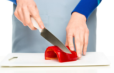 Image showing Cook is chopping bell pepper